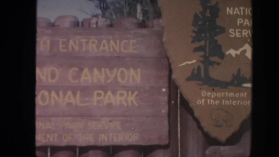 Close 1962 view of the Grand Canyon National Park entrance board with National Park Service signage at the edge.