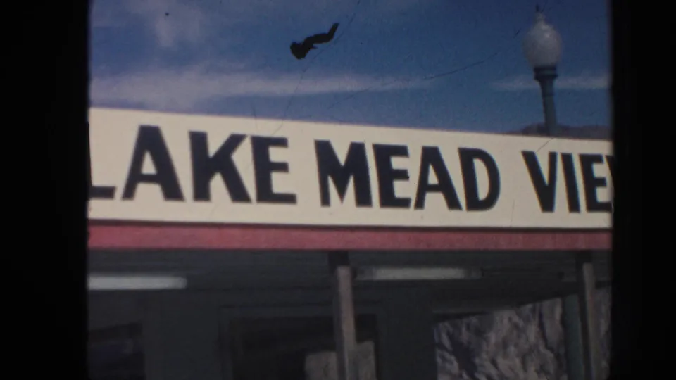 1962 roadside frame showing a Lake Mead View business sign, likely from an Arizona travel route.