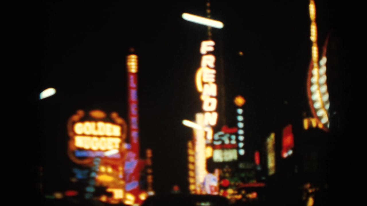 Golden Nugget sign and vertical Fremont sign glowing against a black night sky.