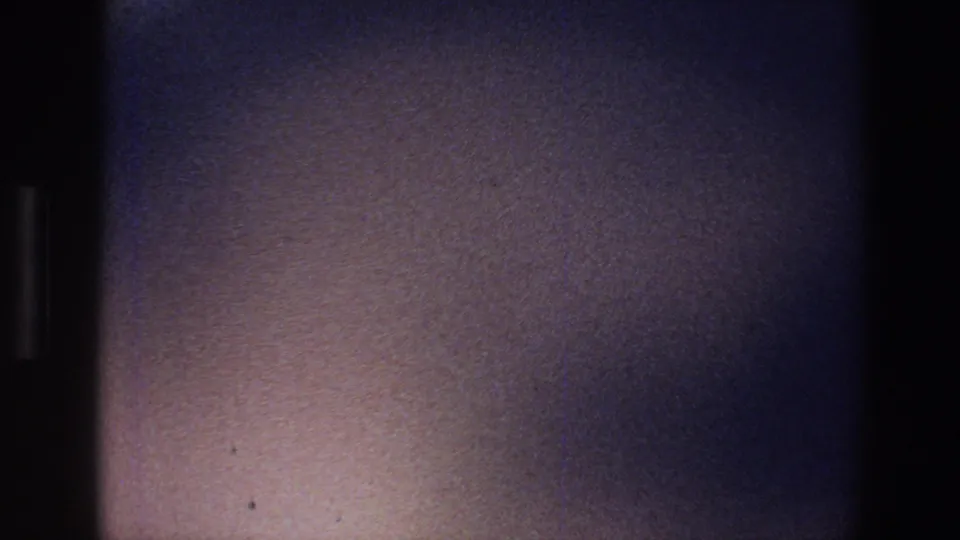 1973 Minnesota 8mm frame with a purple-tinted, blurred interior surface and dark edge framing.