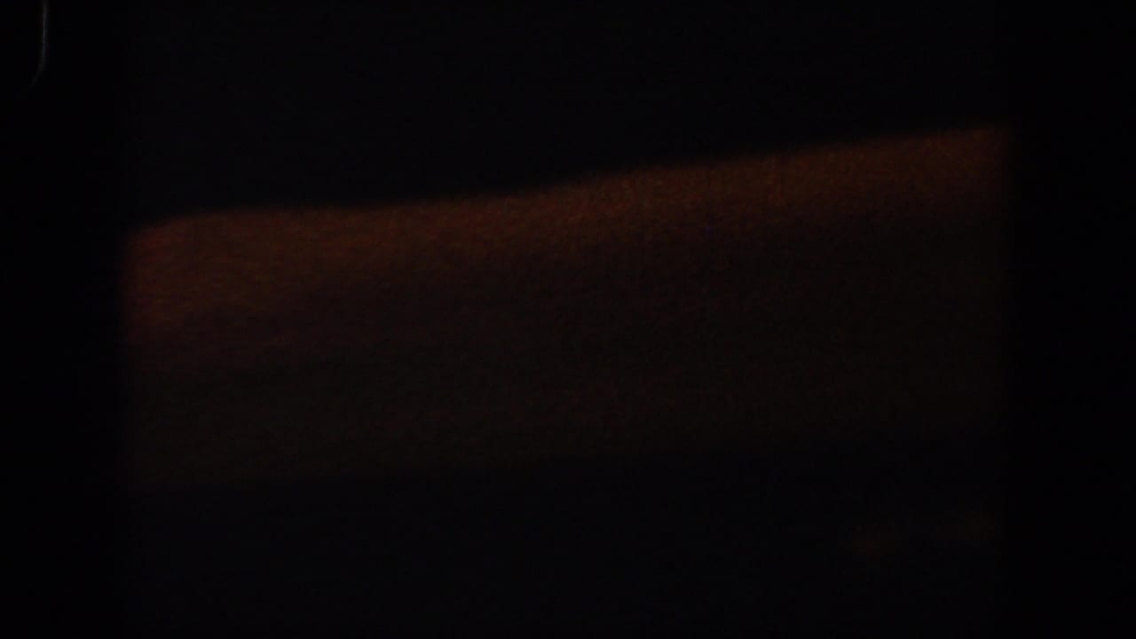 Dark frame with a large dim orange rectangle and surrounding black shadow.