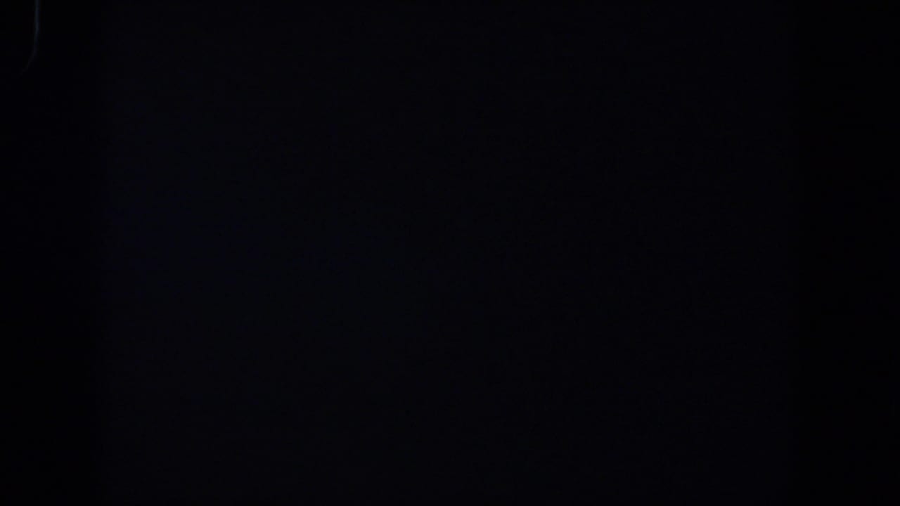 Nearly black 1958 8mm frame from Lubbock metadata, with only faint grain and edge marks visible.