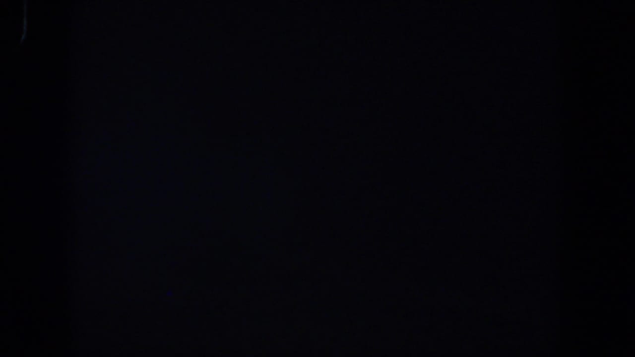 Dark 8mm frame with no visible subjects, showing subtle grain and underexposed film texture.