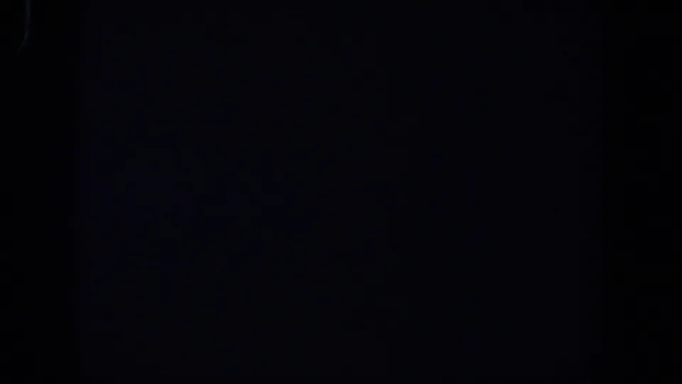 Nearly black 1958 8mm frame from a Lubbock home-movie reel, with faint grain and no visible objects or people.