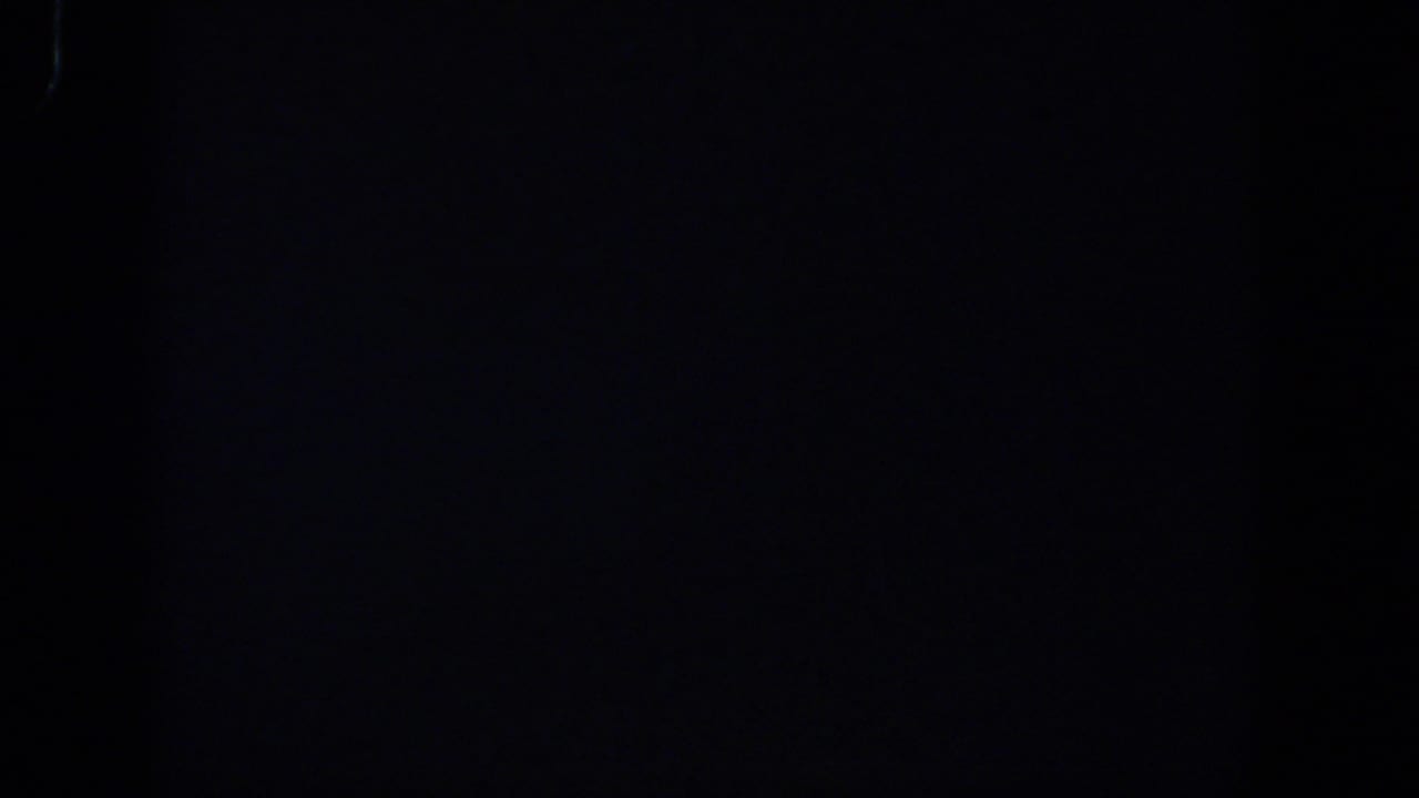 Dark frame with faint grain, slight banding, and no discernible objects.