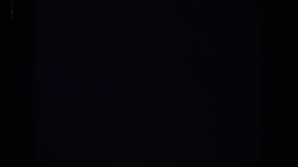 Dark 1958 Lubbock 8mm frame showing faint film grain, low exposure, and no identifiable subjects or objects.