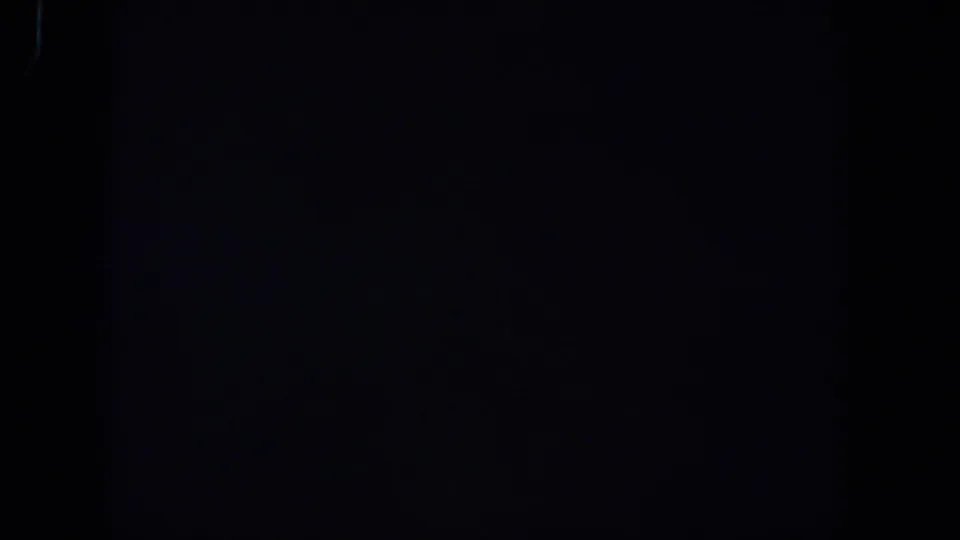 Very dark 1958 Lubbock 8mm frame, showing faint texture and no visible people, property, or readable details.