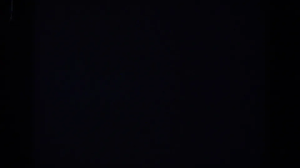 Final near-black frame from the 1958 Lubbock 8mm clip, with grain and no identifiable subject.