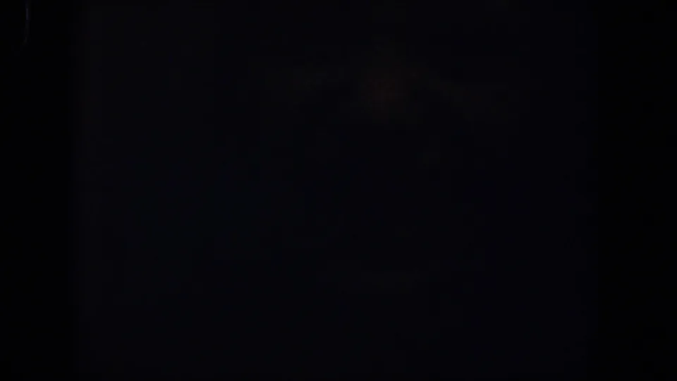 Dark 1958 Lubbock 8mm frame showing subtle grain, low exposure, and no identifiable figures, objects, or setting.