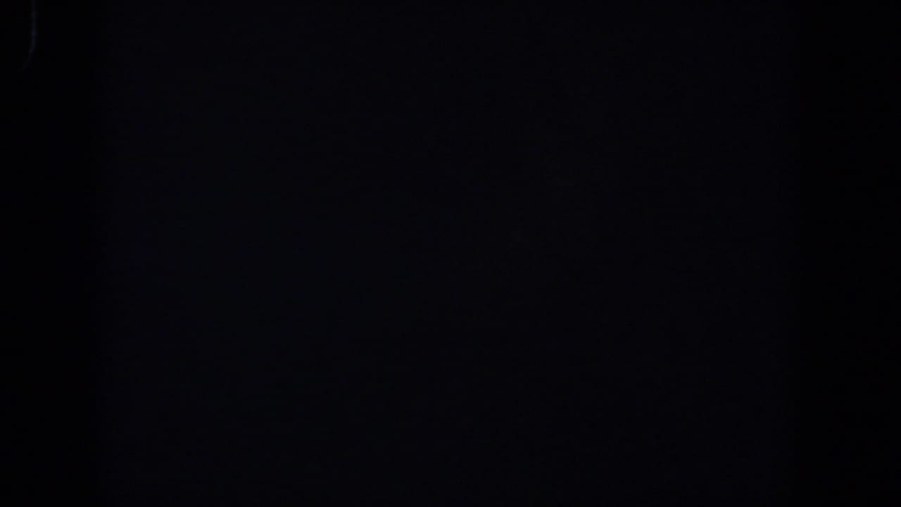 Dark frame with a faint vertical division and slight film texture.