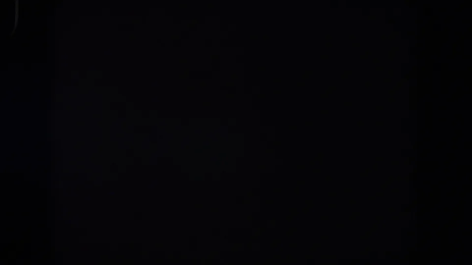 1958 Lubbock 8mm frame returning to near-total darkness, with slight grain and minimal visible detail.