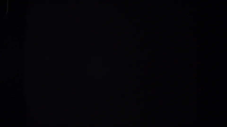 Almost uniform black 8mm frame from the 1958 Lubbock clip, with only subtle grain and vertical film texture visible.