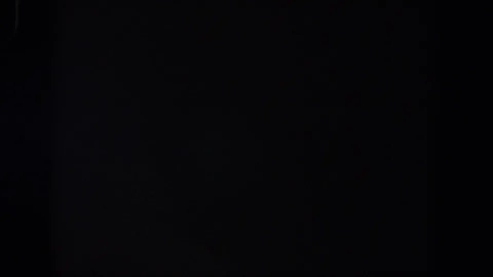 Dark 8mm frame from the 1958 Lubbock reel metadata, showing faint analog grain and no identifiable scene.
