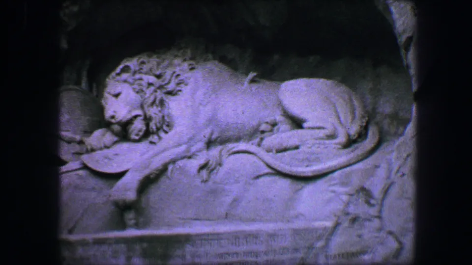 Close 1963 Lucerne view of the Lion Monument carving, with the lion resting above the memorial inscription area.