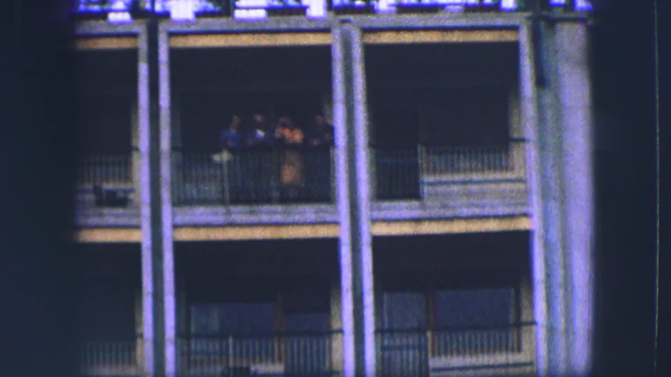 Saint Moritz home-movie frame focusing on balcony railings and vertical columns on a resort-style building exterior.