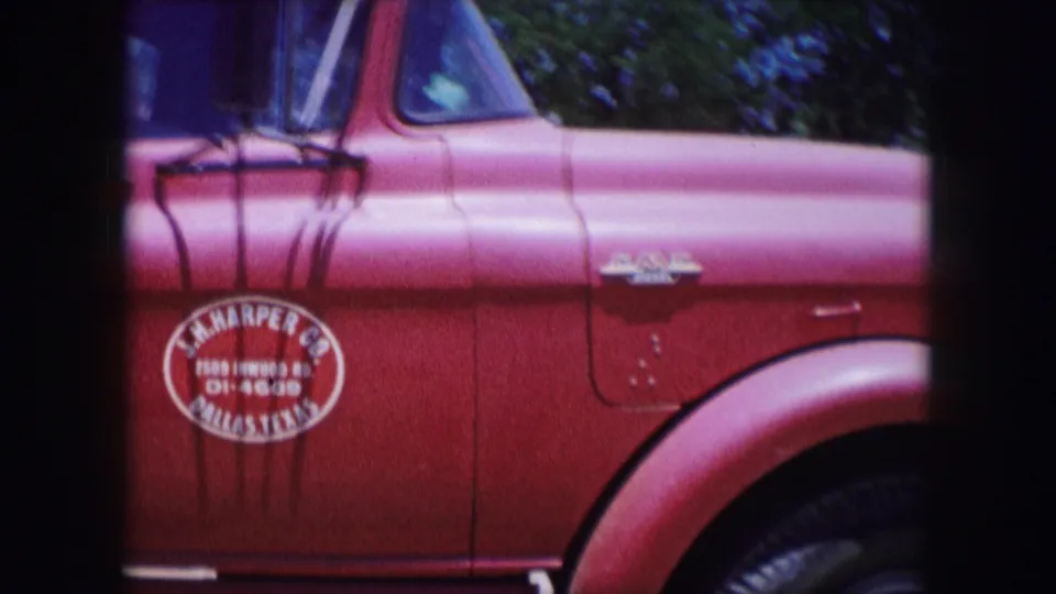 Dallas 1964 metadata frame showing the red truck side, mirror, front wheel, chrome trim, and a visible painted door marking.