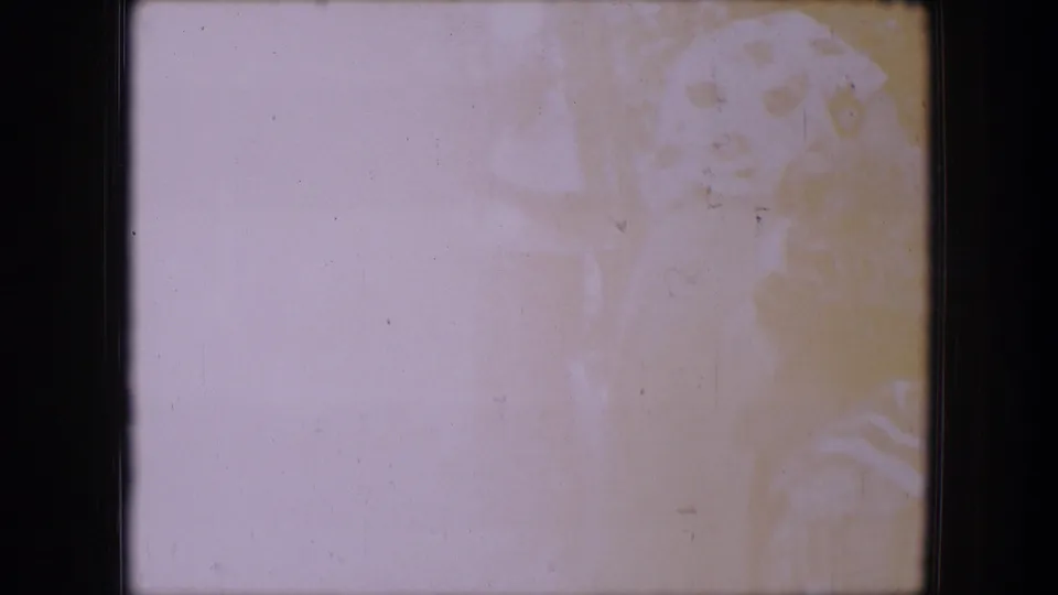 Heavily overexposed 1964 Dallas home-movie frame with faint outlines of people and outdoor foliage.