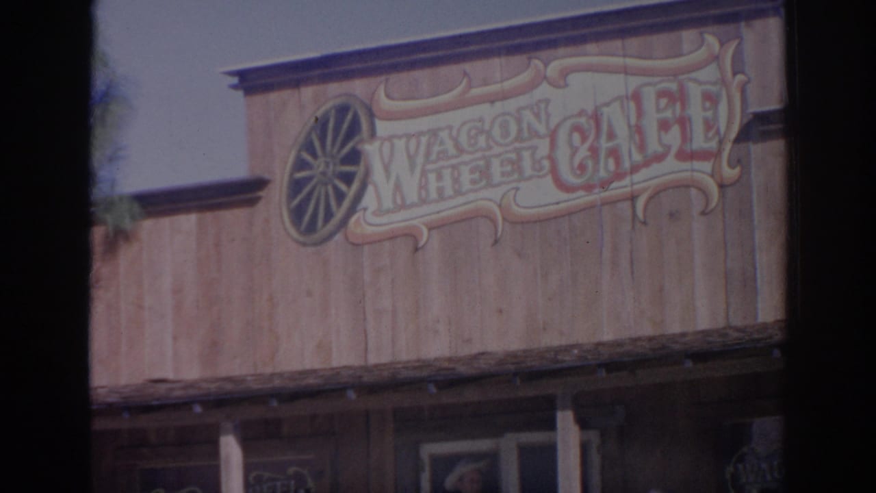 1969 Sarasota frame of the Wagon Wheel Cafe sign painted on a wooden facade above the porch.