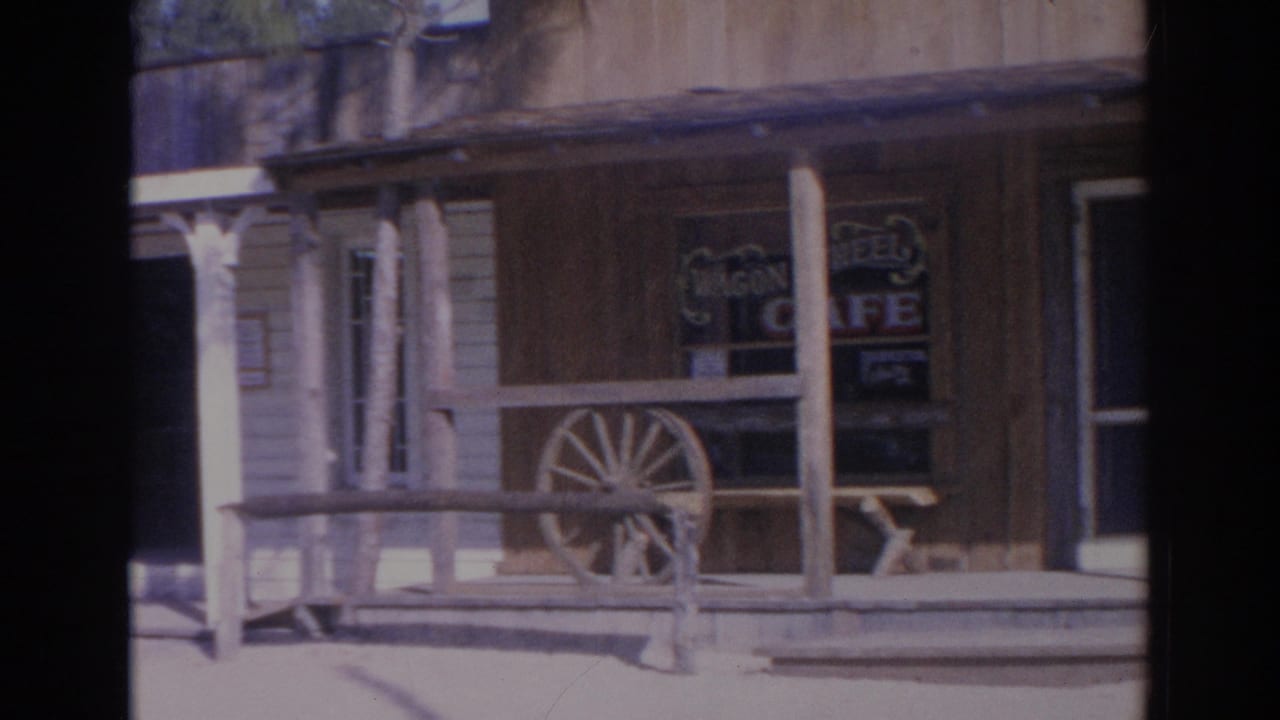 1969 Sarasota frame showing the Wagon Wheel Cafe porch, windows, wooden rails, and wagon wheel decor.