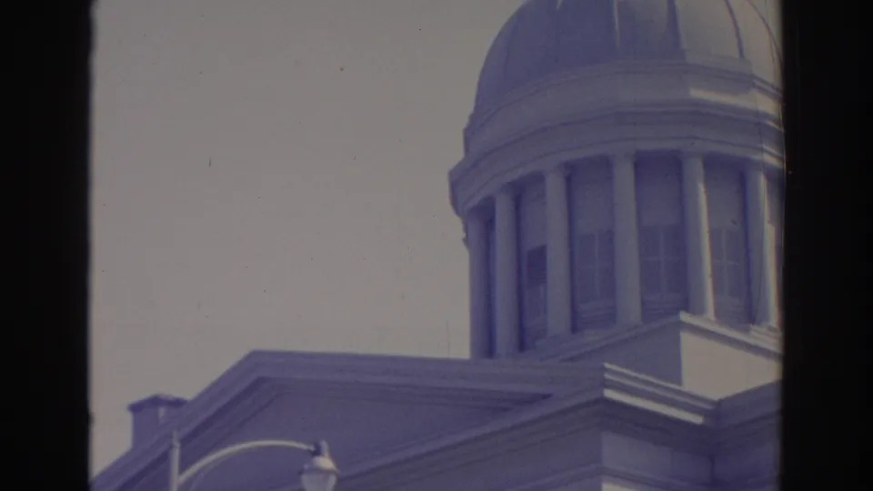 A visitor-shot 1969 Sarasota view shows the upper portion of a domed public-looking building with columns and a pale sky.