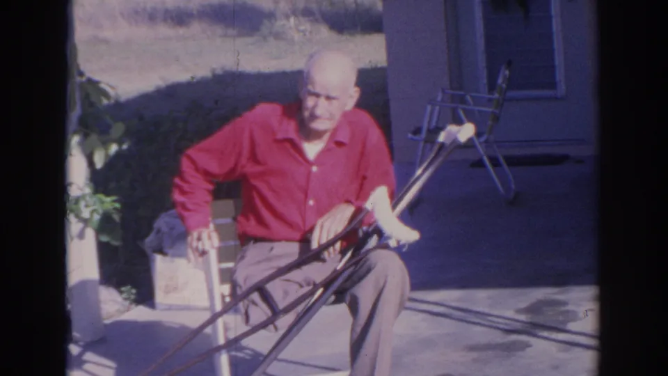 The final frame shows the older man seated on a Sarasota patio in 1969, with a doorway, folding chair, plants, and lawn visible.